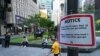 FILE - A notice on restrictions on the size of groups to stop the spread of the Covid-19 coronavirus is pictured on a lamp post in Singapore on March 29, 2022. (Photo by Roslan RAHMAN / AFP)