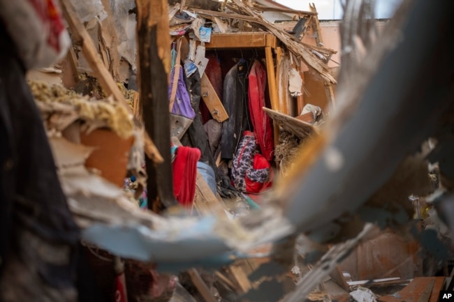 Clothes of Shevchenko's family are photographed inside their house in Irpin, near Kyiv, on Tuesday, May 3, 2022. (AP Photo/Emilio Morenatti)