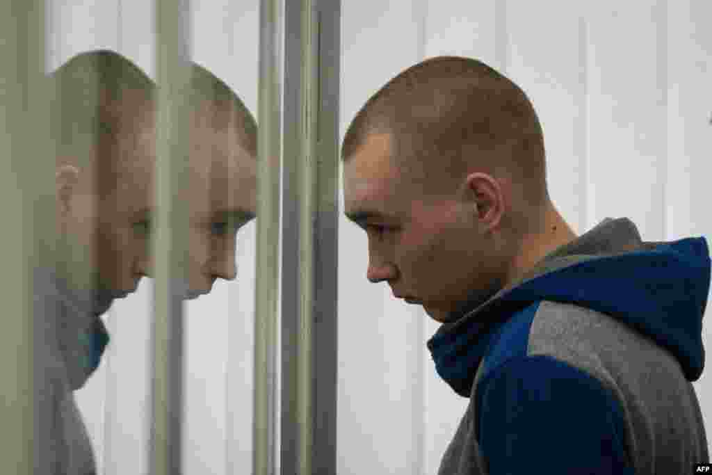 Russian Sergeant Vadim Shishimarin listens to a translator's words in the defendant's box during his trial on charges of war crimes for having killed a civilian, at the Court of Appeal in Kyiv, Ukraine.