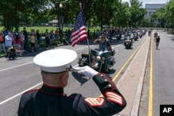 Staf Korps Marinir AS Sersan. Tim Chambers memberi hormat saat peserta reli sepeda motor "Rolling to Remember", jelang Memorial Day, di Washington, Minggu, 29 Mei 2022. (Foto: AP/Jose Luis Magana)