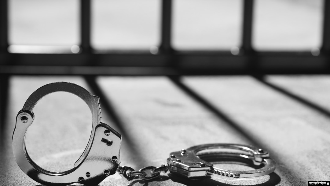 Handcuff and prison bars