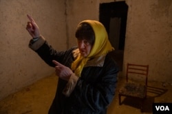 "Part of my family lives in Russia," says Vera from the basement of her home, damaged by battle. "I was born in the Soviet Union. I never ever could imagine that there would be a war, we are brothers," she adds on April 22, 2022, in Kharkiv, Ukraine. (Yan Boechat/VOA)