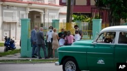Diplomats from several countries wait outside the court building where a trial is going on for Cuban artists Luis Manuel Otero Alcantara and Maykel Castillo in Havana, Cuba, May 30, 2022. 