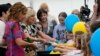 First lady Jill Biden and first lady of Romania Carmen Iohannis greet people during their visit to a school in Bucharest Romania, May 7, 2022, to meet students and the educators who are teaching displaced Ukrainian children.