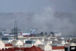 In this Aug. 26, 2021, file photo smoke rises from a deadly explosion outside the airport in Kabul, Afghanistan. (AP Photo/Wali Sabawoon, File)