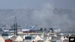 In this Aug. 26, 2021, file photo smoke rises from a deadly explosion outside the airport in Kabul, Afghanistan. (AP Photo/Wali Sabawoon, File)