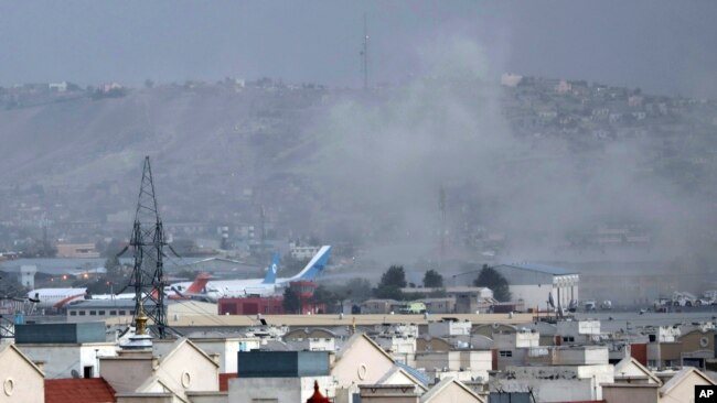 In this Aug. 26, 2021, file photo smoke rises from a deadly explosion outside the airport in Kabul, Afghanistan. (AP Photo/Wali Sabawoon, File)