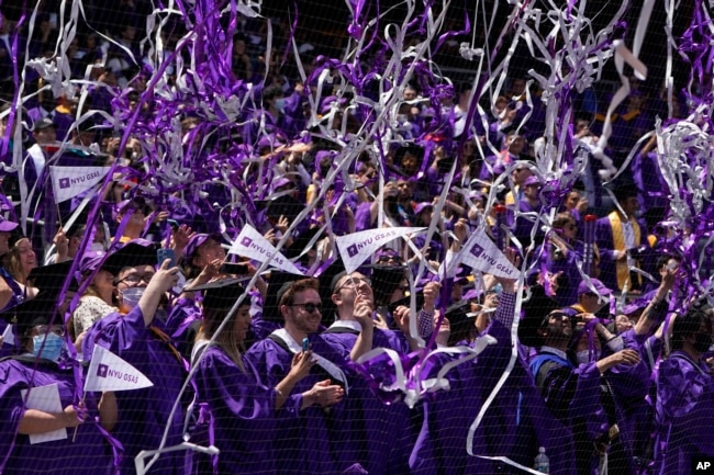 FILE - Confetti drops on graduates as they celebrate at Yankee Stadium on May 18, 2022. (AP Photo/Seth Wenig)