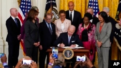 President Joe Biden signs an executive order in the East Room of the White House, May 25, 2022, in Washington. The signing of the order focused on policing came on the second anniversary of George Floyd's death.