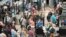 FILE - Travelers queue up move through the north security checkpoint in the main terminal of Denver International Airport, May 26, 2022, in Denver. 