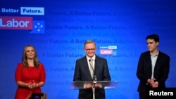 Anthony Albanese, leader of Australia's Labor Party is accompanied by his partner Jodie Haydon and son Nathan Albanese while he addresses his supporters, Sydney, Australia, May 21, 2022.