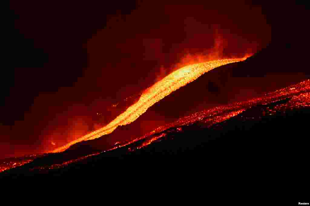 Lava flows downhill as Mount Etna erupts, as seen from Pizzi Deneri on the north side of volcano, on the island of Sicily, in Catania, Italy, May 31, 2022. 