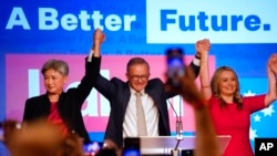 Labor Party leader Anthony Albanese celebrates with his partner Jodie Haydon, right, and Labor senate leader Penny Wong at a Labor Party event in Sydney, Australia, May 22, 2022.