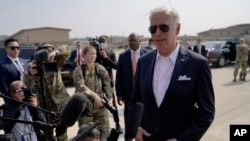 U.S. President Joe Biden, right, speaks before boarding Air Force One for a trip to Japan, at Osan Air Base, in Pyeongtaek, South Korea, May 22, 2022.