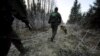 FILE - Finnish border guards patrol at the border between Finland and Russia, Nov. 3, 2009.