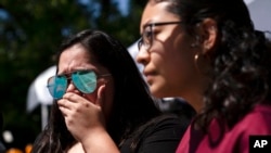 Stefanie Garcia, 28, left, breaks down as she visits Robb Elementary School to pay her respects in Uvalde, Texas, May 25, 2022. Desperation turned to sorrow for families of grade-schoolers killed after an 18-year-old gunman barricaded himself in their Texas classroom and began shooting, killing at least 19 fourth-graders and their two teachers.