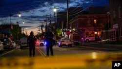 FILE - Police tape surrounds the scene after a second shooting Friday, April 22, 2022, injured three people in Washington, a short distance away from another shooting that occurred earlier in the afternoon.