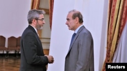 FILE - Iranian Deputy Foreign Minister Ali Bagheri Kani, the country's chief nuclear negotiator, speaks with Enrique Mora, the European Union's Iran nuclear talks coordinator, in Tehran, Iran, May 11, 2022. (Iran Foreign Ministry / West Asia News Agency, via Reuters)