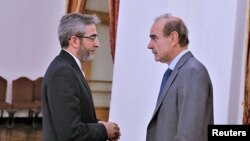 Iranian Deputy Foreign Minister Ali Bagheri Kani, the country's chief nuclear negotiator, speaks with Enrique Mora, the European Union's Iran nuclear talks coordinator, in Tehran, Iran, May 11, 2022. (Iran Foreign Ministry / West Asia News Agency, via Reuters)