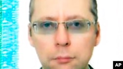 An undated image taken with permission from the passport photo page of Russian diplomat Boris Bondarev.