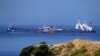 The Pegas tanker, that has recently changed its name to Lana, foreground, is seen off the port of Karystos on the Aegean Sea island of Evia, Greece, May 27, 2022. Greece’s armed forces are on high alert in the Eastern Aegean Sea as tensions escalate with Turkey.