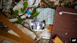 A wedding photograph lies among rubble from a Russian strike earlier in the war in Kramatorsk, eastern Ukraine, May 21, 2022.