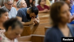 Worshipers gather for a mass at the Sacred Heart Catholic Church a day after a gunman killed 19 children and two teachers at Robb Elementary School, in Uvalde, Texas, U.S. May 25, 2022.