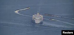 FILE - The USS Lewis B. Puller is seen in a still image from video taken in the Persian Gulf, April 15, 2020.