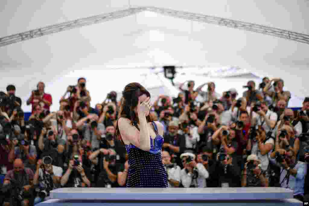 Photographers snap pictures of Anne Hathaway at the photo call for the film "Armageddon Time" at the 75th international film festival, Cannes, southern France.