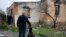Eduard Zelenskyy pets his dog at his home destroyed by attacks in Potashnya, on the outskirts of Kyiv, Ukraine, on May 31, 2022. Zelenskyy just returned to his hometown after escaping war to find out he is homeless. 