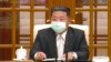 In this image made from video broadcast by North Korea's KRT, North Korean leader Kim Jong Un wears a face mask on state television during a meeting acknowledging the country's first case of COVID-19, May 12, 2022, in Pyongyang, North Korea.