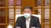 朝鲜领导人金正恩5月12日戴着口罩出席一次会议，承认爆发新冠病毒疫情。（电视画面截图）