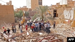 A handout picture provided by the Iranian presidency shows Iranian vice president Mohammad Mokhber (C) visiting the site where a ten-story building collapsed in the southwestern city of Abadan on May 27, 2022.