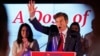 Mehmet Oz, a Republican candidate for U.S. Senate in Pennsylvania, right, waves in front of his wife, Lisa, while speaking at a primary night election gathering in Newtown, Pa., May 17, 2022.
