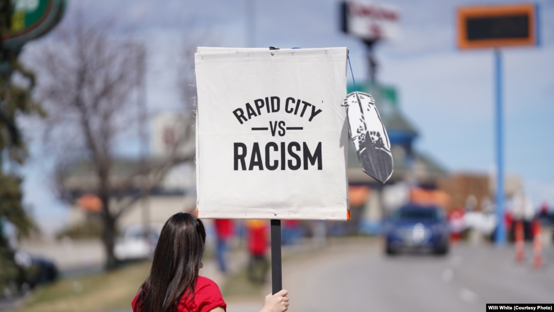 Native American woman participating in NDN Collective protest against racist businesses in Rapid City, S.D., April 20, 2022. 