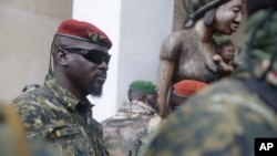 WFILE - Guinea junta leader Col. Mamady Doumbouya, leaves a meeting with an ECOWAS delegation in Conakry, Guinea, Sept. 10, 2021. Coup leaders on Saturday announced a ban on political protests in the country.