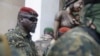 WFILE - Guinea junta leader Col. Mamady Doumbouya, leaves a meeting with an ECOWAS delegation in Conakry, Guinea, Sept. 10, 2021. Coup leaders on Saturday announced a ban on political protests in the country.