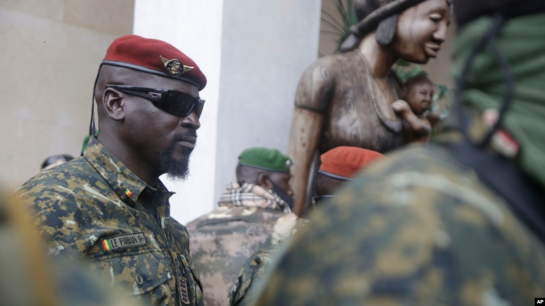 FILE - Guinea junta leader Col. Mamady Doumbouya, leaves a meeting with an ECOWAS delegation in Conakry, Guinea, Sept. 10, 2021. Coup leaders on Saturday announced a ban on political protests in the country.