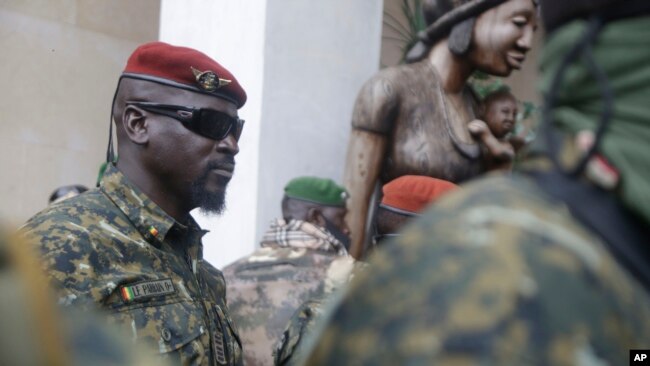 FILE - Guinea junta leader Col. Mamady Doumbouya, leaves a meeting with an ECOWAS delegation in Conakry, Guinea, Sept. 10, 2021. Coup leaders on Saturday announced a ban on political protests in the country.
