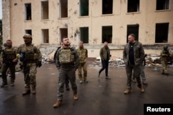 Ukraine's President Volodymyr Zelenskyy visits an area damaged by Russian military strikes, as Russia's attack on Ukraine continues, in Kharkiv, Ukraine, May 29, 2022. (Ukrainian Presidential Press Service/Handout via Reuters)