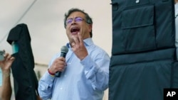 Flanked by bulletproof shields, presidential candidate Gustavo Petro of the Historical Pact coalition speaks at a campaign rally in Fusagasuga, Colombia, May 11, 2022.