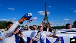 Real Madrid fans cheer in front of the Eiffel Tower Paris. Liverpool and Real Madrid will face each other in the Champions League final.