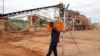 FILE - A private security employee guards a diamond processing plant in the diamond-rich eastern Marange region on December 14, 2011.