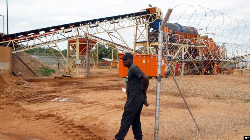 FILE - A private security employee guards a diamond processing plant in the diamond-rich eastern Marange region on December 14, 2011.