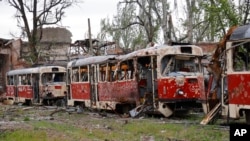 Destroyed trams stand in a depot in Mariupol, in territory under the government of the Donetsk People's Republic, eastern Ukraine, May 21, 2022.