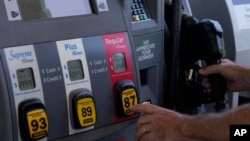 FILE: A customer pumps gas at an Exxon gas station, in Miami, Florida. Taken 5.10.2022