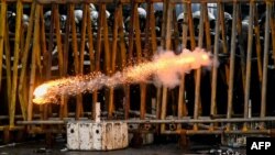 Police fire tear gas shells to disperse students taking part in an anti-government protest demanding the resignation of Sri Lanka&#39;s President Gotabaya Rajapaksa over the country&#39;s crippling economic crisis, in Colombo.