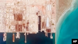 This satellite photo from Planet Labs PBC shows the Iranian Revolutionary Guard's newest ship, the Shahid Mahdavi, center right, under construction in a shipyard west of Bandar Abbas, Iran, May 21, 2022.