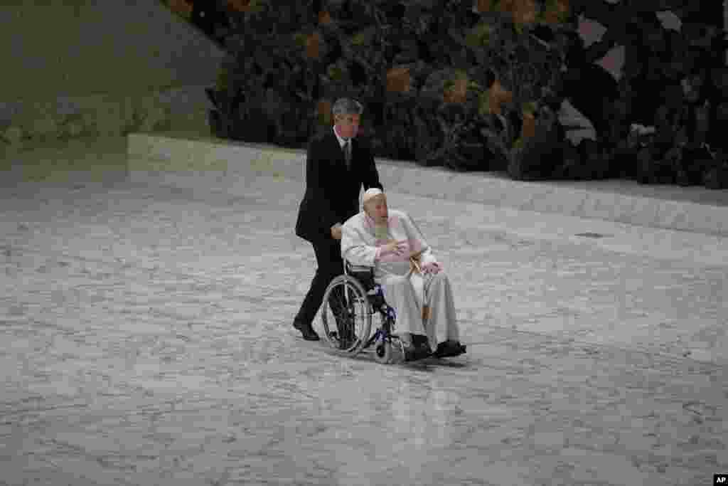 Pope Francis arrives in a wheelchair to attend an audience with nuns and religious superiors in the Paul VI Hall at The Vatican.&nbsp;Francis, 85, has been suffering from strained ligaments in his right knee for several months.