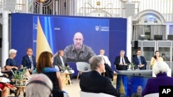 FILE - Denys Shmyhal, Ukraine's prime minister, is seen on a video screen during a G-7 finance ministers meeting near Bonn, Germany, May 19, 2022.